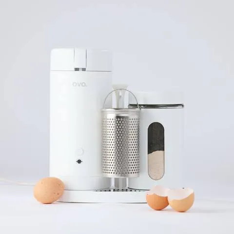 OVO Eggshell Grinder. The grinder mechanism visible through the body, with eggshells alongside.